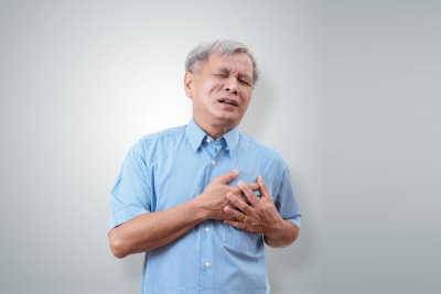 senior man clutching and having chest pain cause of heart attack